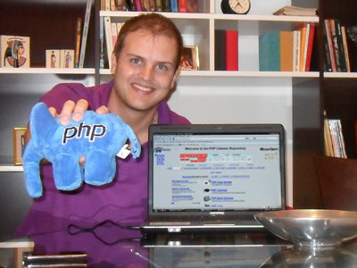 Picture of Guilherme Ribas holding the elePHPant PHP mascot toy